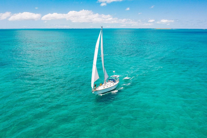 A sailboat sailing on the ocean on a sunny day